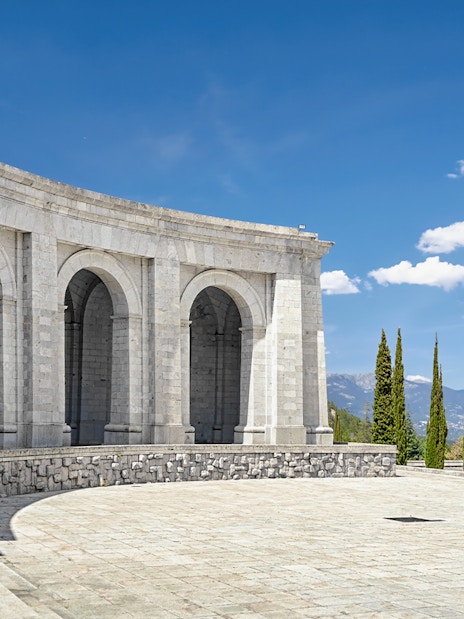 Monument arches at Valley of the Fallen, Spain, with mountain view.