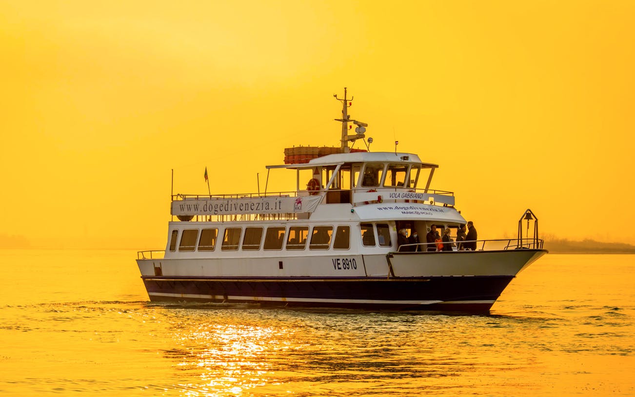 Ferry cruising at sunset during the Guided Sunset Panoramic Tour in Venice from Punta Sabbioni.