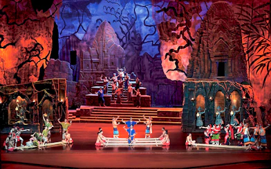 Performers on stage at Siam Niramit Phuket, depicting a cultural scene with traditional costumes.