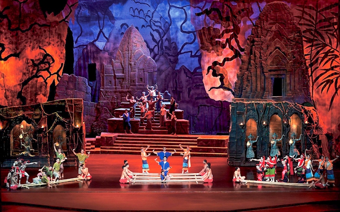 Performers on stage at Siam Niramit Phuket, depicting a cultural scene with traditional costumes.