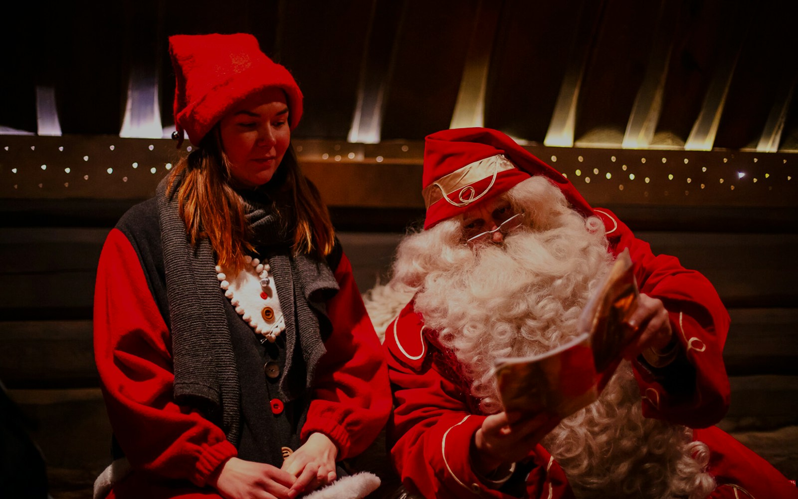 Santa Claus reading to a visitor at Santa Claus Village, Lapland.