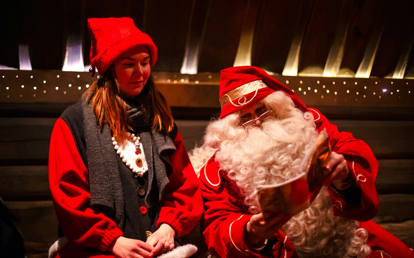 Santa Claus reading to a visitor at Santa Claus Village, Lapland.