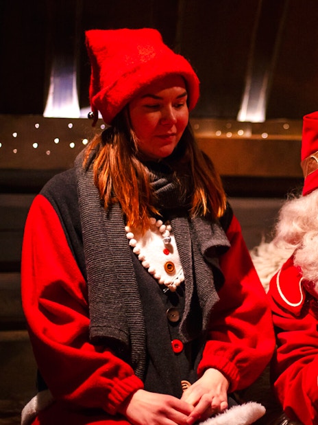 Santa Claus reading to a visitor at Santa Claus Village, Lapland.