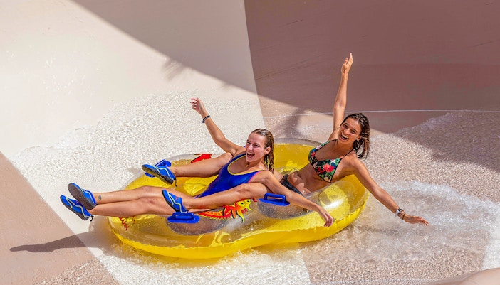Tourists enjoying a thrilling water ride at Siam Park, Tenerife.