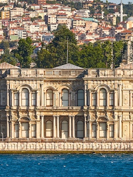 Ortaköy Mosque by the Bosphorus with Istanbul cityscape in the background.