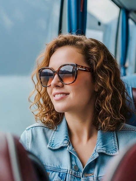 Traveler enjoying scenic view from AC coach, Hallstatt.