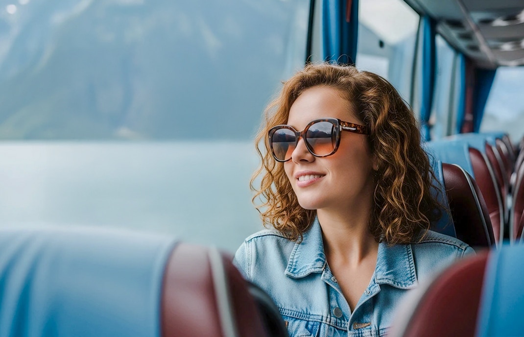 Traveler enjoying scenic view from AC coach, Hallstatt.