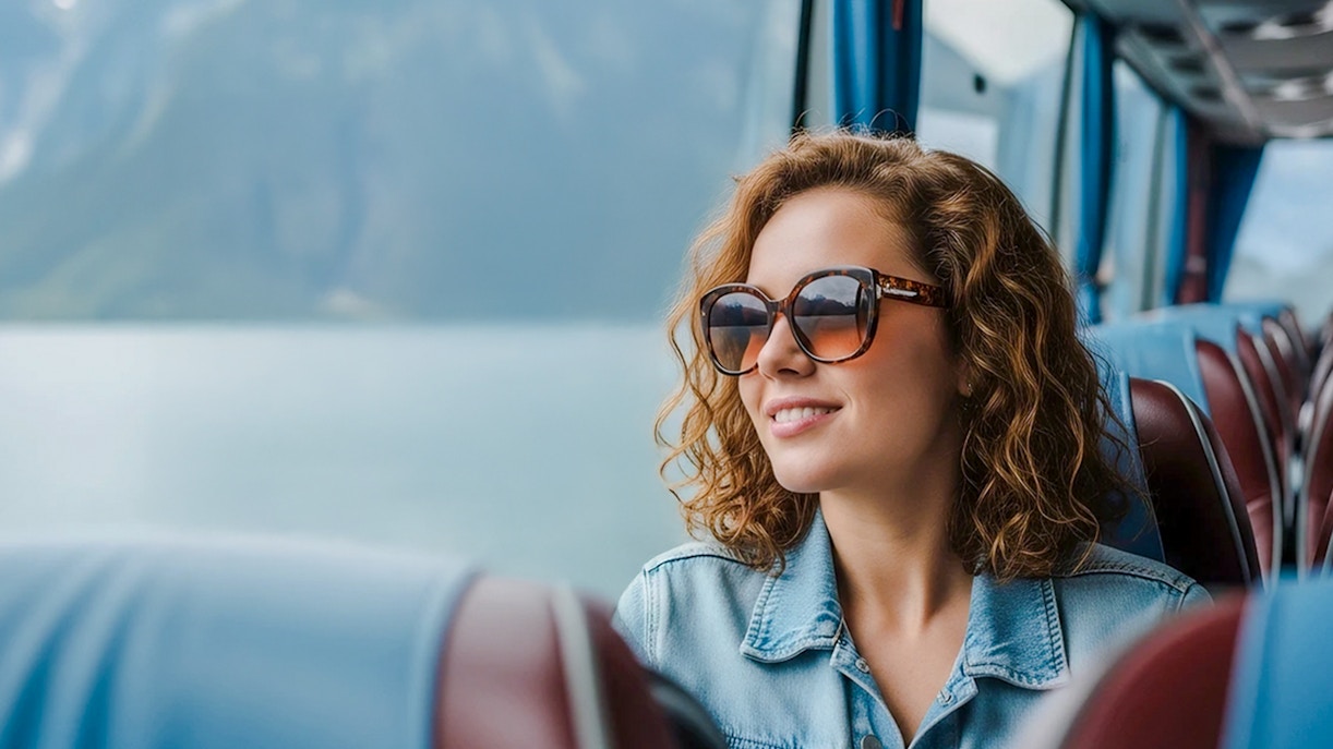 Traveler enjoying scenic view from AC coach, Hallstatt.