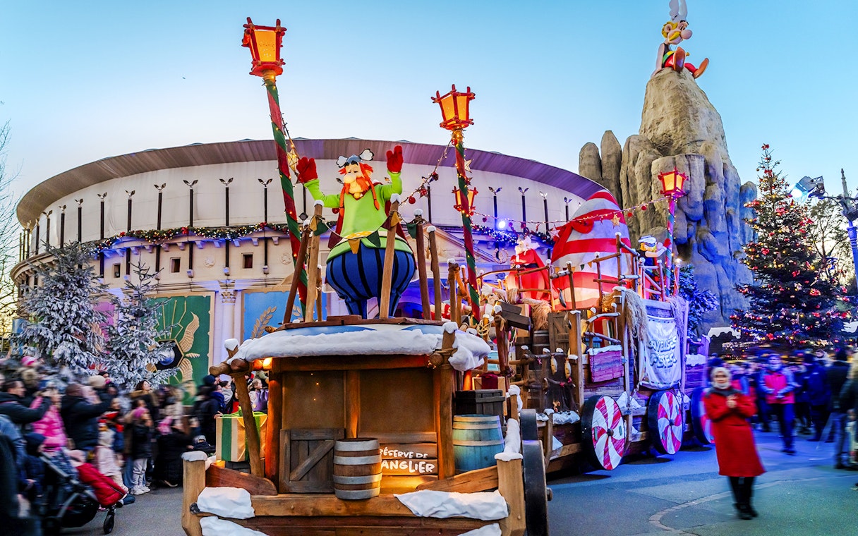 Parc Asterix Christmas parade with festive decorations and characters.
