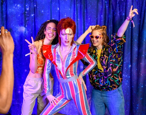 Visitors posing with a wax figure at Madame Tussauds, part of the Harry Potter™ Warner Bros. Studio Tour combo.