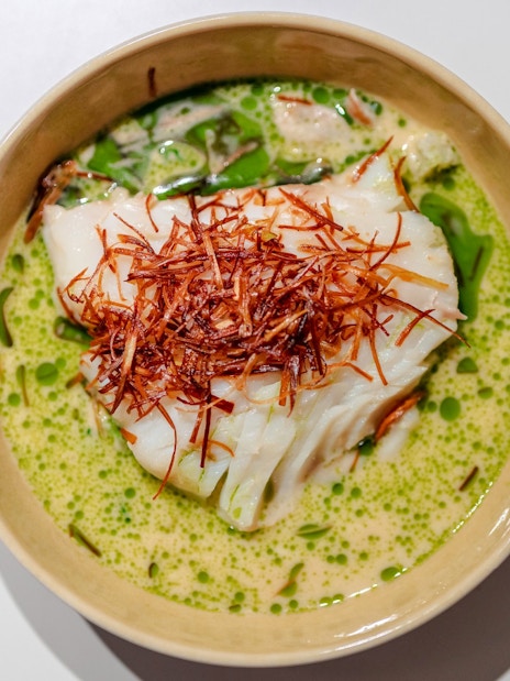 White fish with crispy garnish in green sauce, served on a Stavanger dinner cruise.