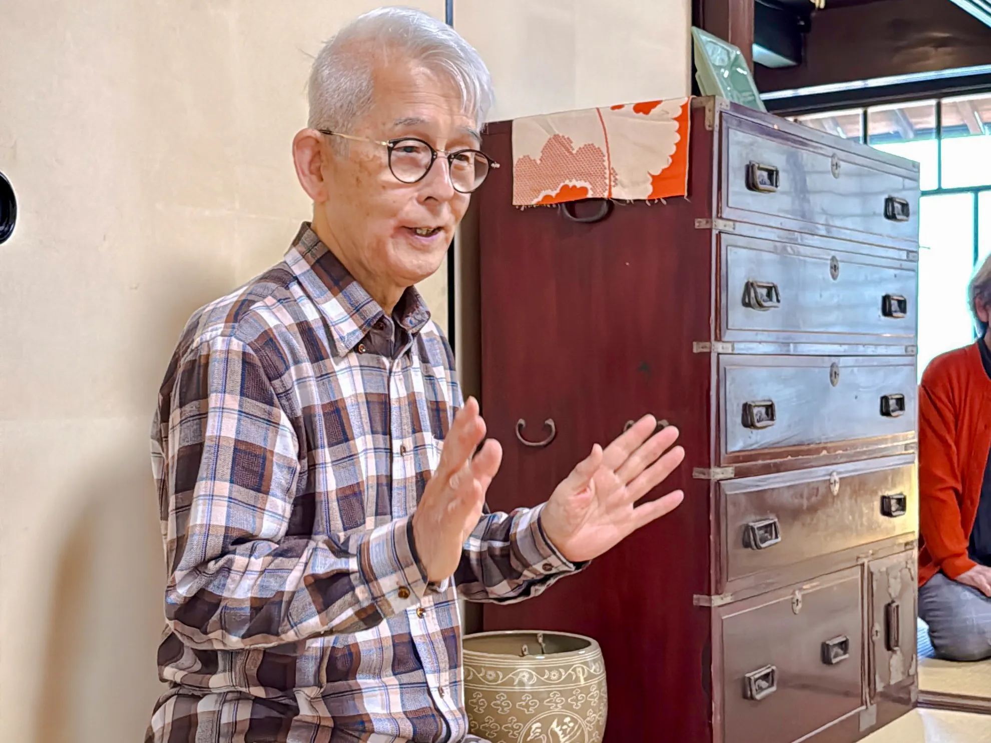 Elderly man explaining tea ceremony at cultural house in Hyogo.