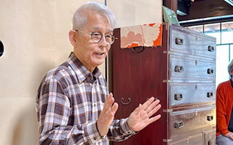 Elderly man explaining tea ceremony at cultural house in Hyogo.