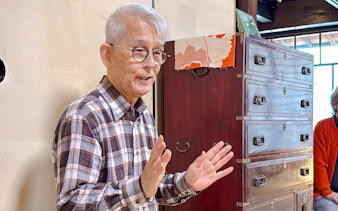 Elderly man explaining tea ceremony at cultural house in Hyogo.