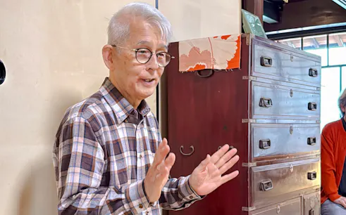 Elderly man explaining tea ceremony at cultural house in Hyogo.