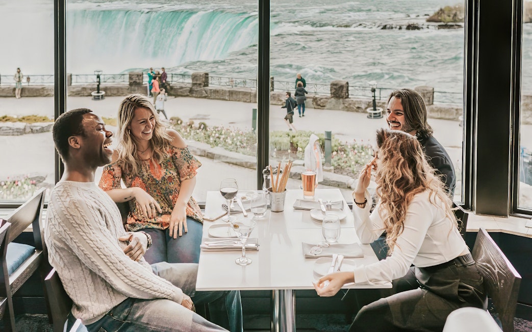 Dining with a view of Niagara Falls on a Toronto day tour with Hornblower Cruise.