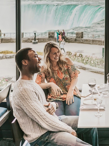 Dining with a view of Niagara Falls on a Toronto day tour with Hornblower Cruise.