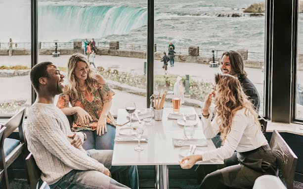Dining with a view of Niagara Falls on a Toronto day tour with Hornblower Cruise.