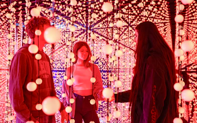 Visitors exploring Bubble Planet light installation in Washington DC.