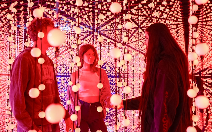Visitors exploring Bubble Planet light installation in Washington DC.