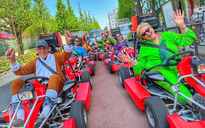 Tourists in costumes driving go-karts on the street in Akihabara, Tokyo.