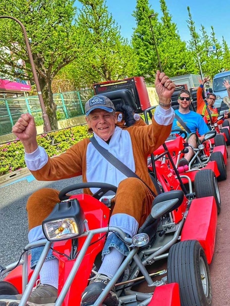 Tourists in costumes driving go-karts on the street in Akihabara, Tokyo.