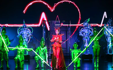 Performers in vibrant costumes at Calypso Cabaret show, Bangkok.