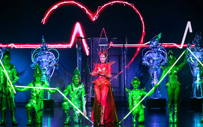 Performers in vibrant costumes at Calypso Cabaret show, Bangkok.