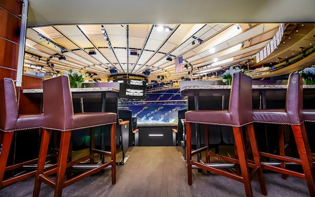 Luxury seating area overlooking Madison Square Garden arena during guided tour.