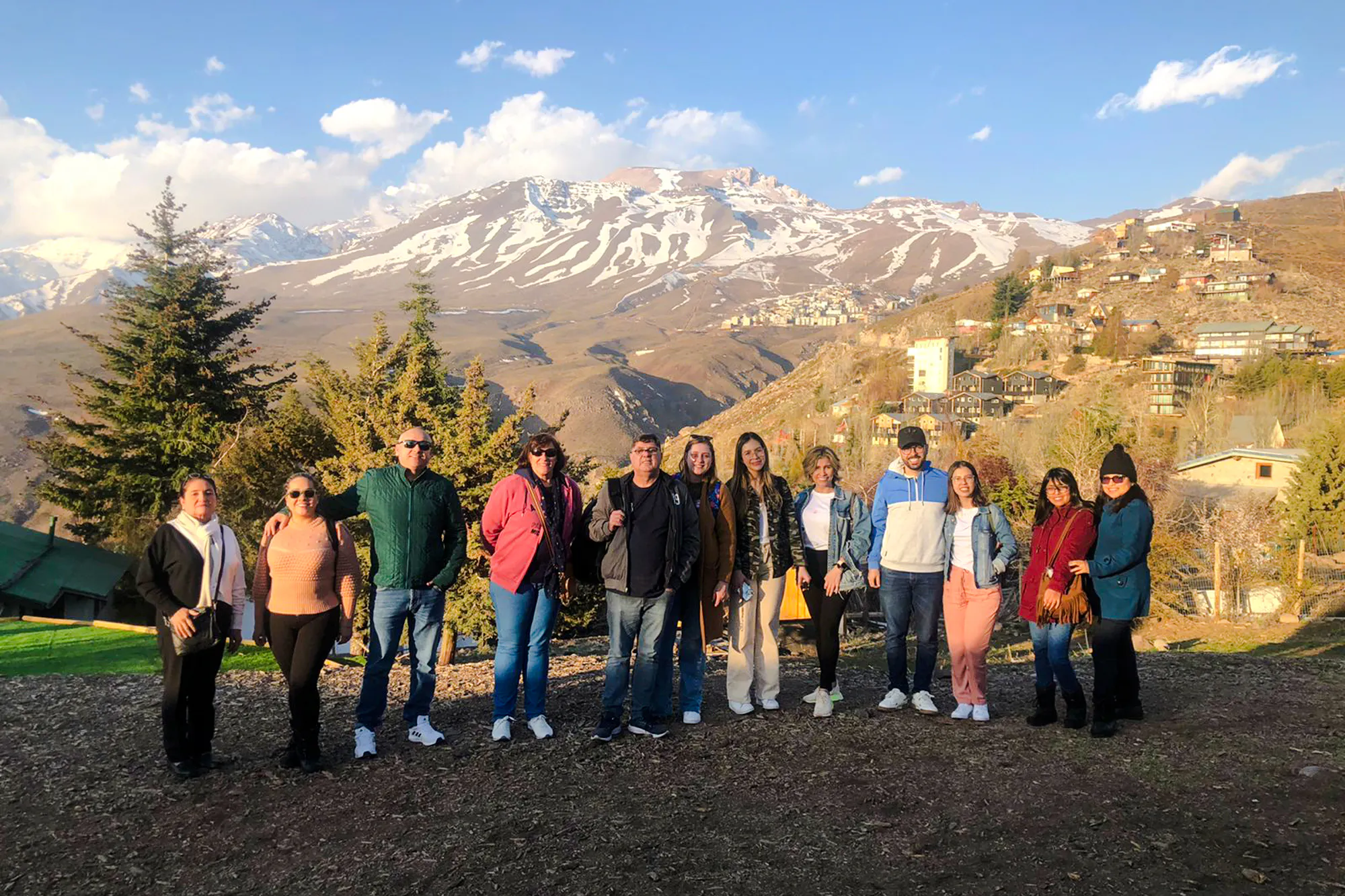 Group of tourists with Andes Mountains backdrop near Santiago.