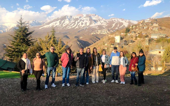 Group of tourists with Andes Mountains backdrop near Santiago.