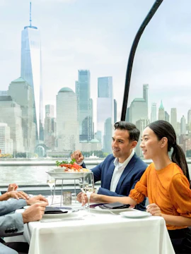 Dining on a New York City cruise with skyline views in the background.