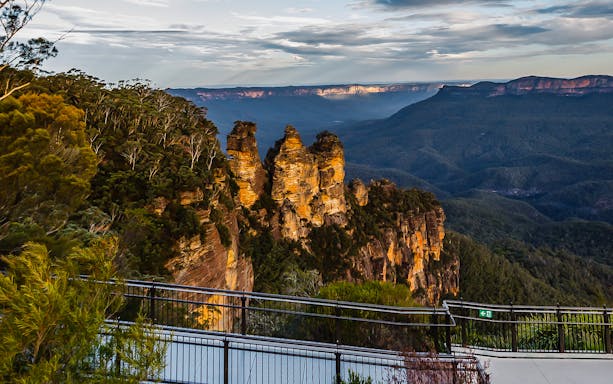 Three Sisters rock formation in Blue Mountains, Australia, viewed from an observation deck.