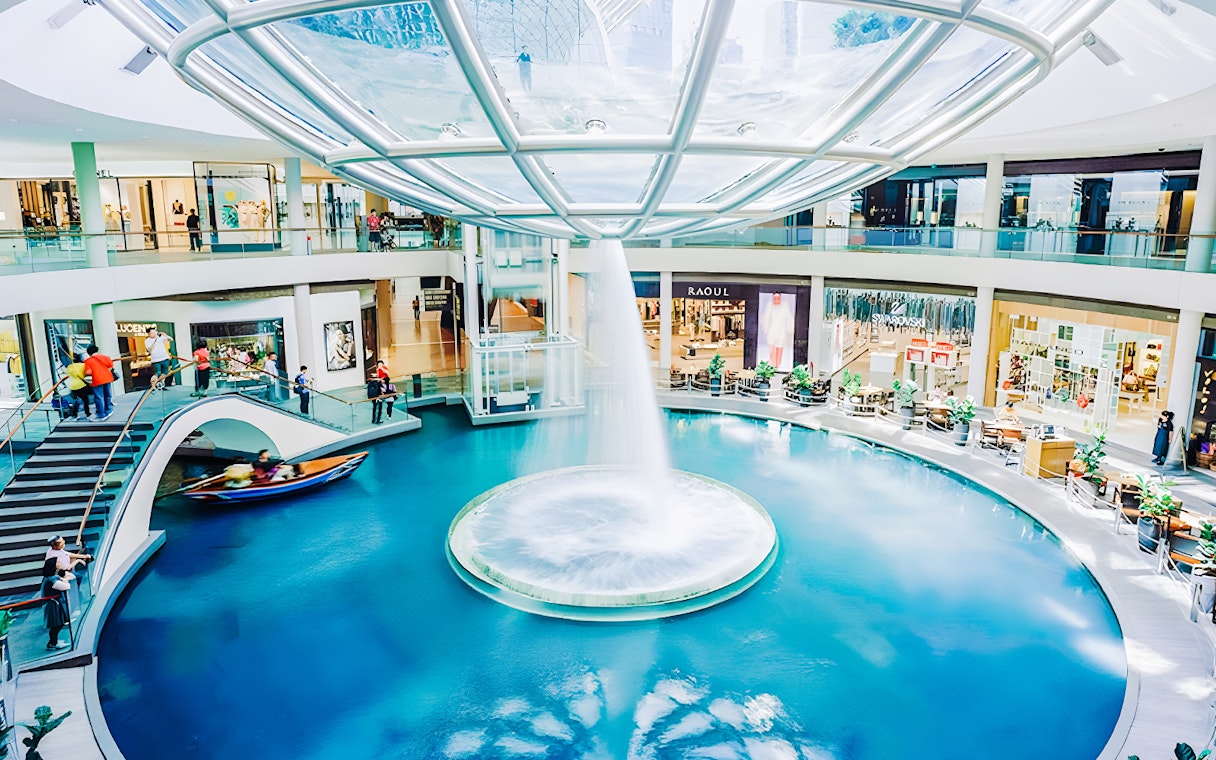 Indoor canal and waterfall feature inside Marina Bay Sands shopping mall.