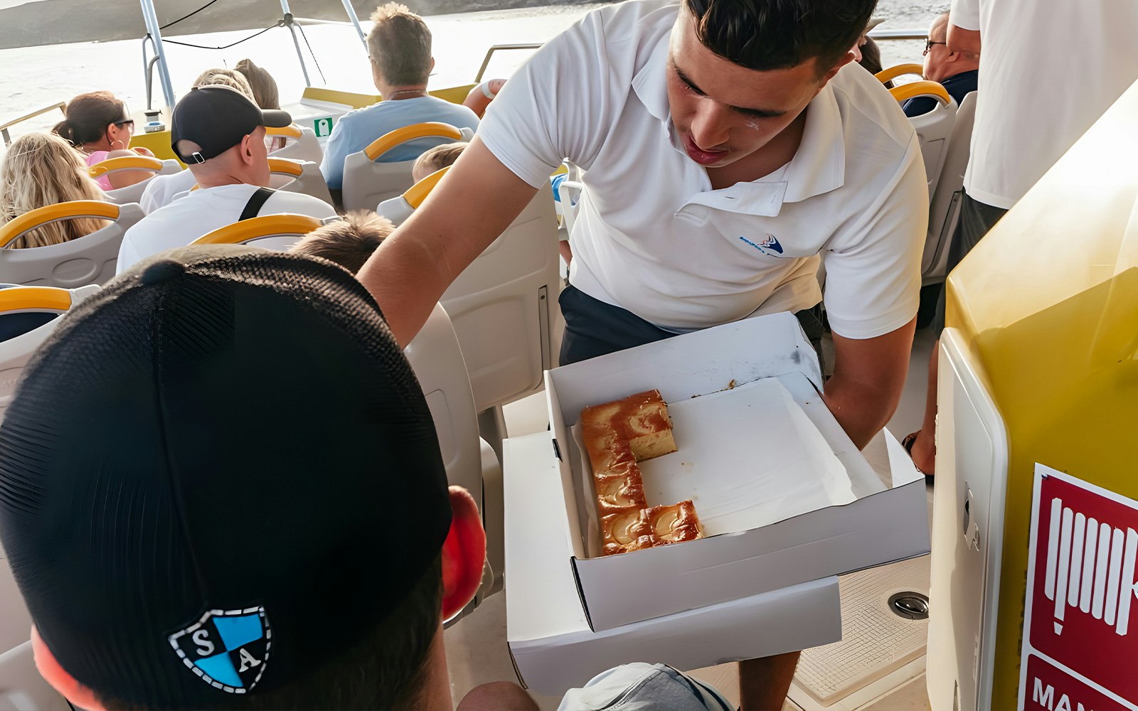 Tourist receiving snacks on a speedboat during Sunset Dolphin Cruise.