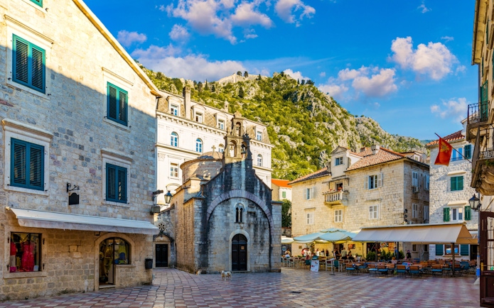 St. Luke's Square in Kotor's Old Town with historic buildings and a small church.