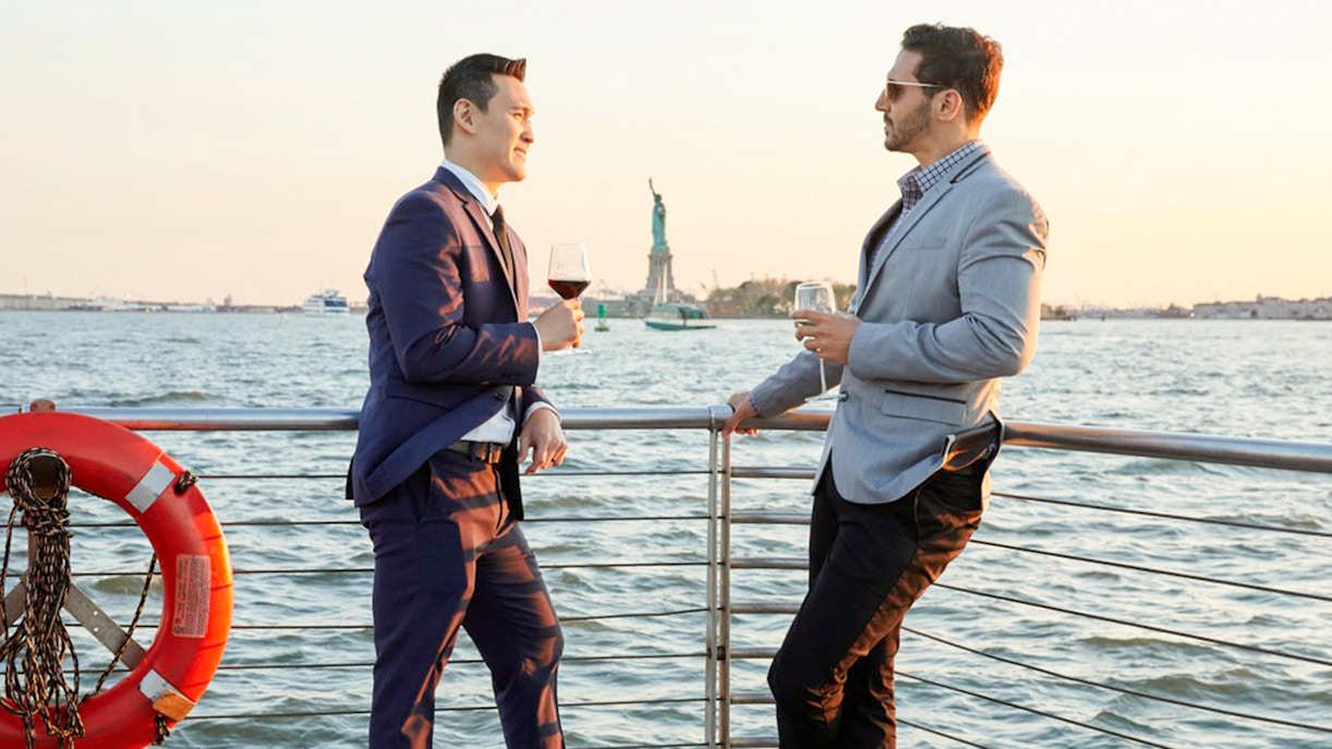 Passengers enjoying the Bateaux New York Premier Lunch Cruise with a view of the city skyline