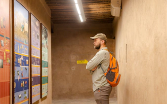 Visitor examining historical displays at Nizwa Fort during Muscat day trip.