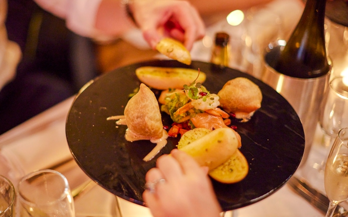 Dinner plate with assorted appetizers on Showboat Vivid Sydney cruise.