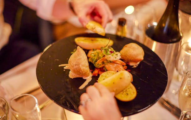 Dinner plate with assorted appetizers on Showboat Vivid Sydney cruise.