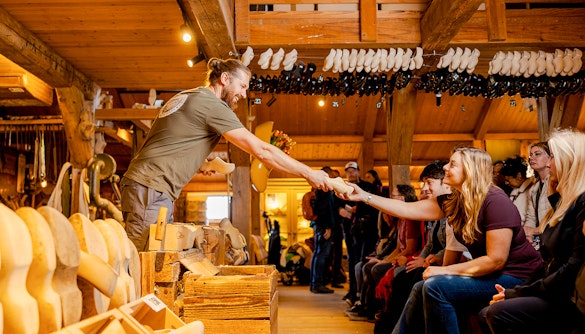 Guests receiving wooden clogs at Zaanse Schans during a guided tour.