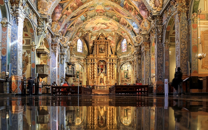 San Nicolas Church interior with ornate frescoes and gilded altar, Valencia, Spain.