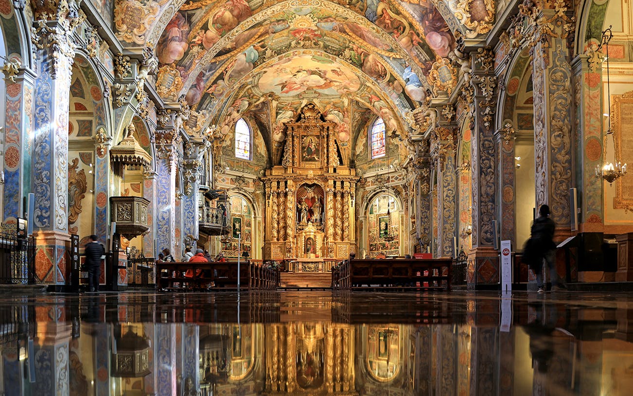 San Nicolas Church interior with ornate frescoes and gilded altar, Valencia, Spain.