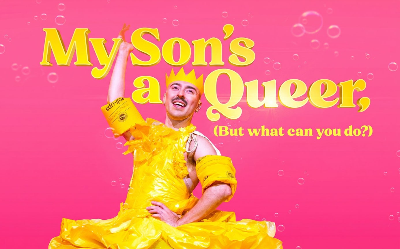 Performer in yellow costume with text "My Son's a Queer, (But What Can You Do?)" on pink background, Westend.