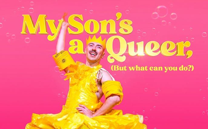 Performer in yellow costume with text "My Son's a Queer, (But What Can You Do?)" on pink background, Westend.
