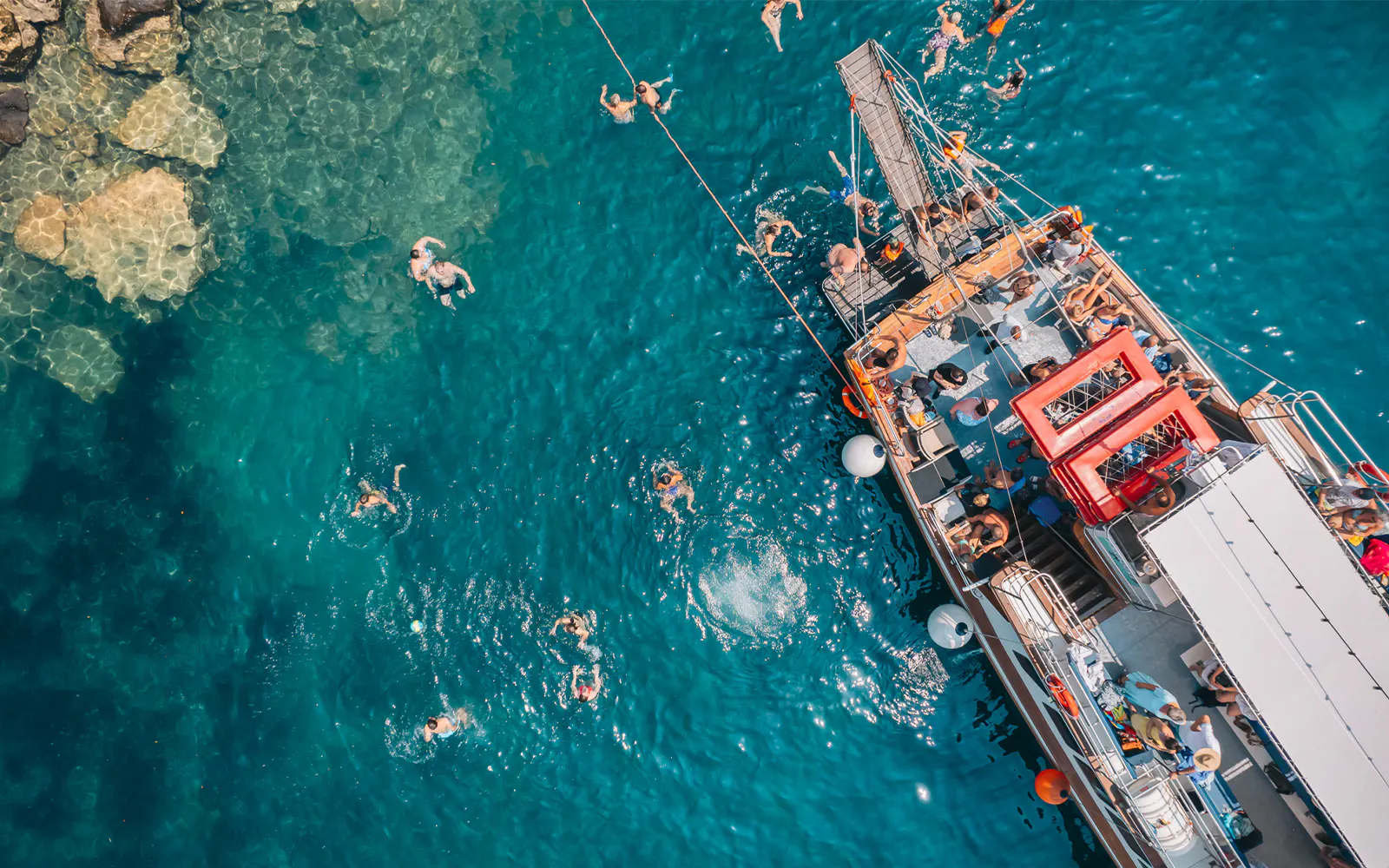 Cruise ship with swimmers in Blue Lagoon, Greece, during Papanikolis tour from Benitses.