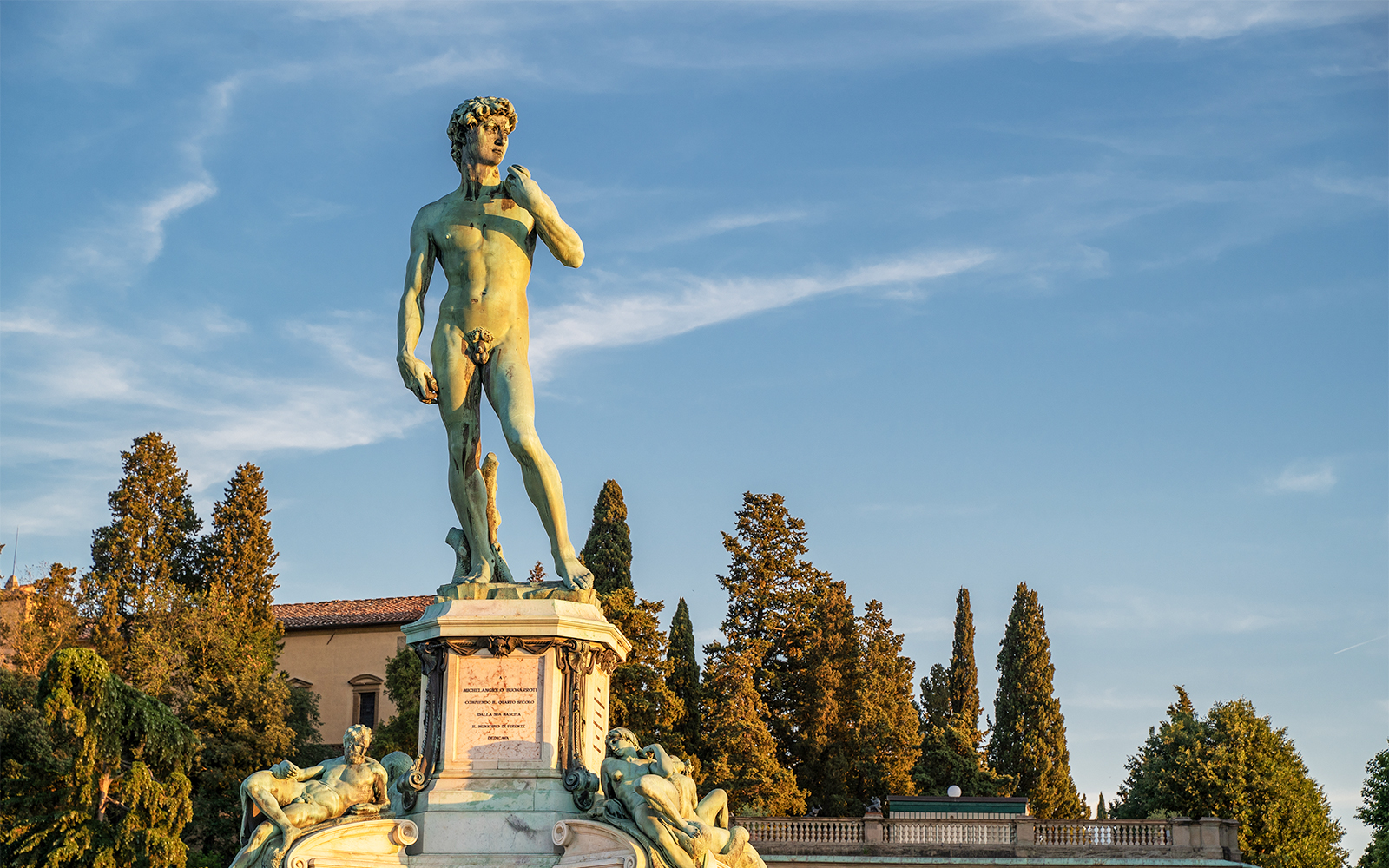 Statue of David at Piazzale Michelangelo, Florence, with trees in the background.