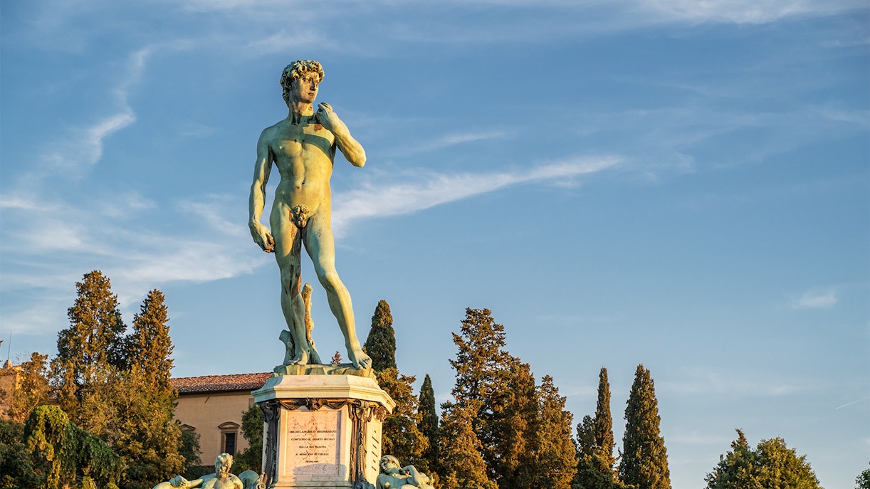 Statue of David at Piazzale Michelangelo, Florence, with trees in the background.