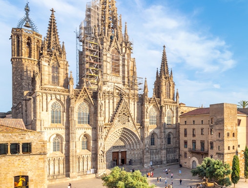 Cathedral of Barcelona with visitors in the plaza, showcasing Gothic architecture.
