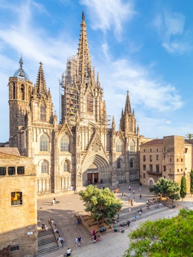 Cathedral of Barcelona with visitors in the plaza, showcasing Gothic architecture.